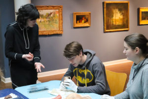 Students examine ancient artifacts