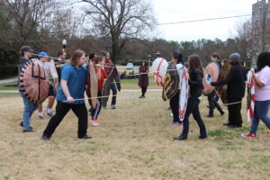 Egyptology students test their homemade shields on the academic quad