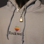 Rockwell hoodie with chain, lock, and key necklace on a mannequin