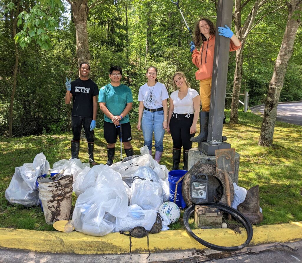 Students stand with the trash they collected during a campus clean ups during the week leading up to Earth Day.