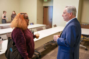Oglethorpe University President Nick Ladany speaks with a student in his 'Helping Skills' class.