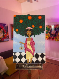 "Divinidad" by Sophia Sobrino. Oil on masonite painting of a young girl in a white dress and pink shawl with an orange tree behind her.