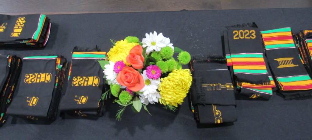 Table set up of the Kente stoles with a bouquet of flowers