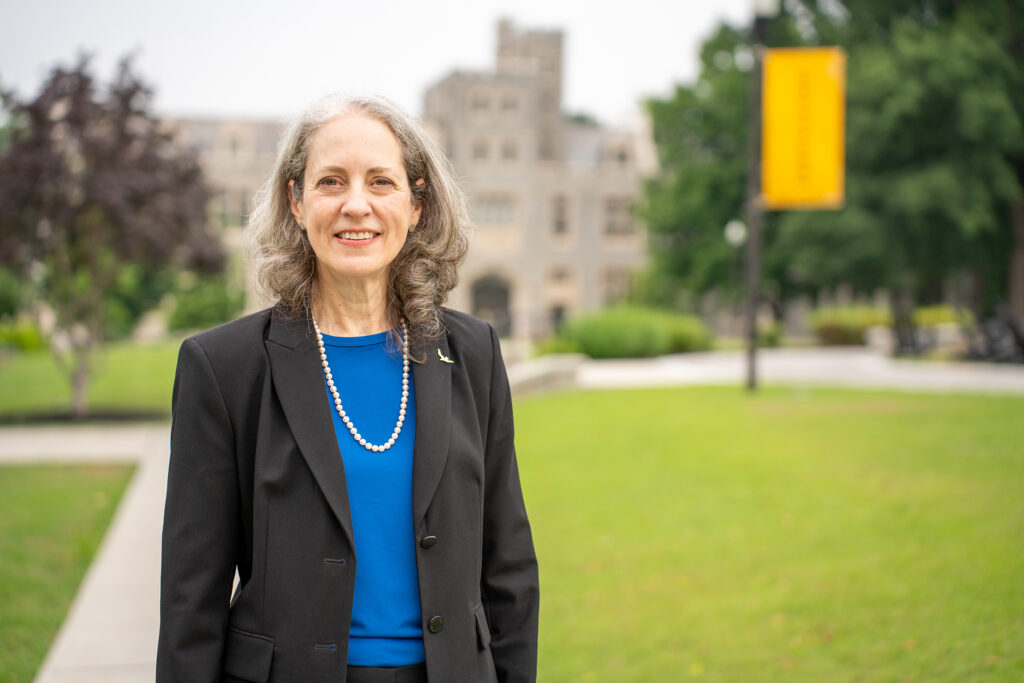 Dr. Kathryn McClymond, Interim President of Oglethorpe University stands on the quad in front of Lowry Hall