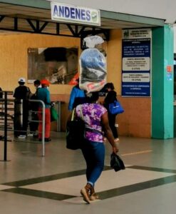 An Afro-Ecuadorian woman carrying goods on her head.