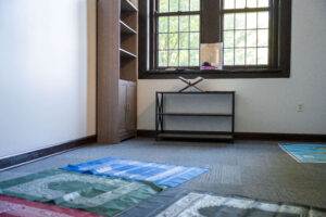 Prayer rugs, bookshelves and books in the interfaith prayer and meditation space