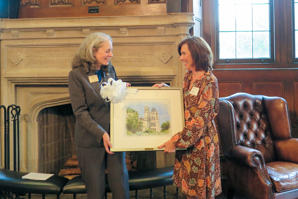 OU President Kathryn McClymond with alumna Donna Rasile '82 in Hearst Hall with a watercolor of Lupton Hall -- a parting gift for Rasile as she concluded her service to the President's Advisory Council. 