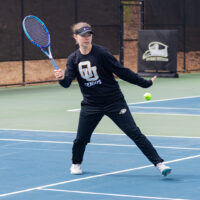 Izzy Forster playing tennis at Oglethorpe's Downing Howell Tennis Court.