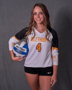 Young woman in volleyball uniform with volleyball