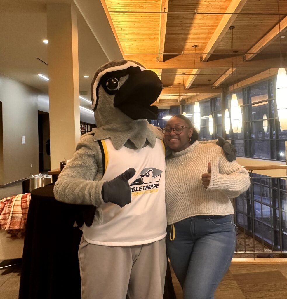 Petey mascot with Senior Class President Randi Parks in the campus center.