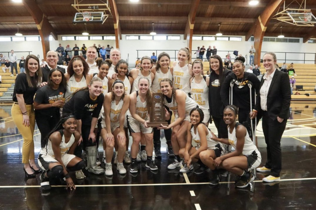 The 2019-2020 women's basketball team posing with the SAA Championship trophy.