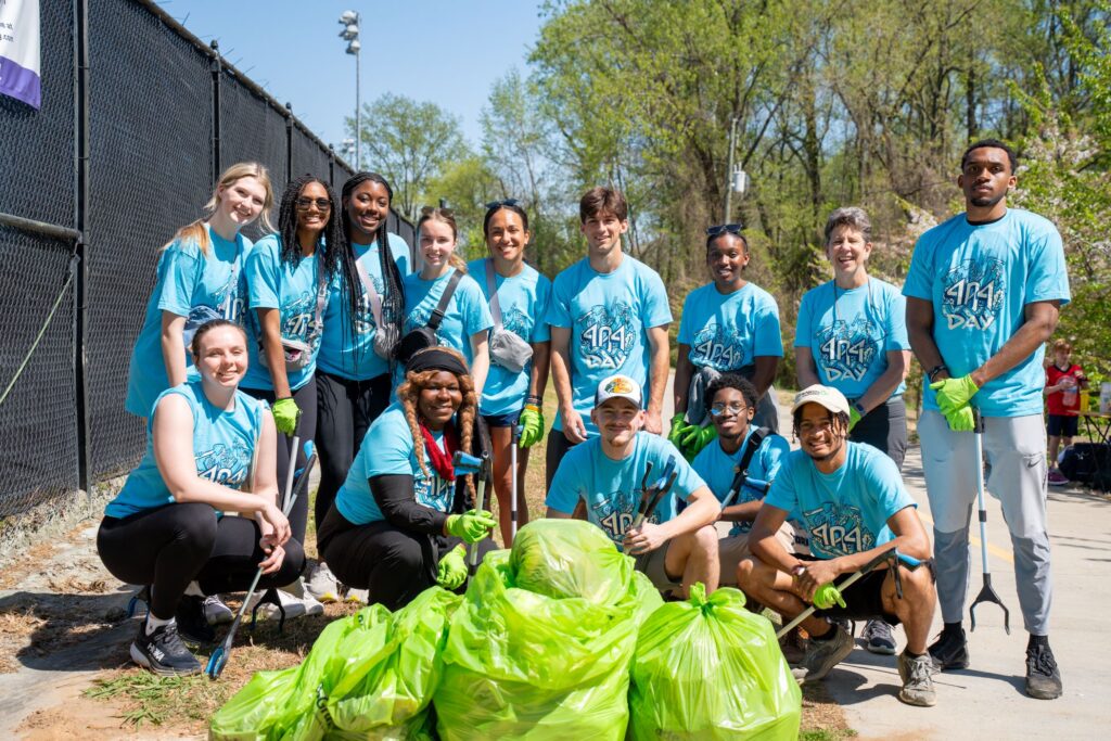 Oglethorpe students posing with the trash collected during a day of service along the Atlanta BeltLine