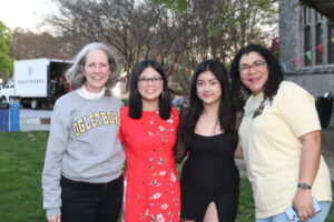 Nathania Adhisty and Morgan Quach pose for a photo with Intercultural Center Director Marisol Zacarias and President McClymond
