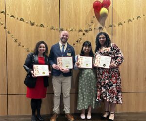 Student success director Vivian Medrano, assistant director of community and global engagement Peter Dye, admissions counselor and Dream.Us advisor Meri Flores, and Intercultural Center director Marisol Zacarias pose with awards they received at the gala.