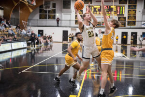 Oglethorpe men's basketball player takes a shot from the court.